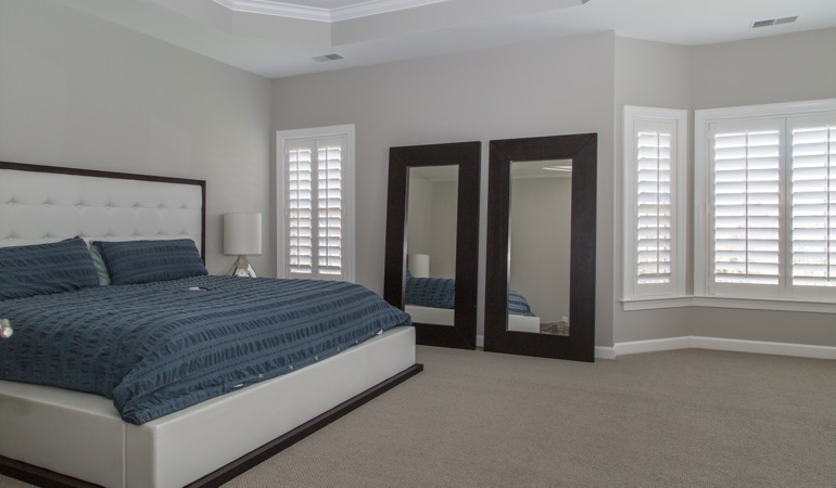 White shutters in a minimalist bedroom in Minneapolis.